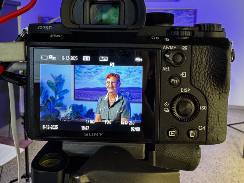 A camera monitor framing an interviewee on set.