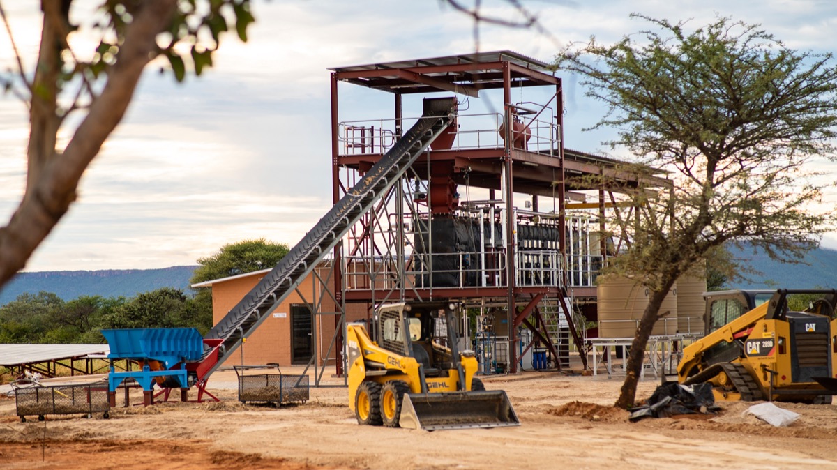 The SteamBio processing plant near Otjiwarongo, with a conveyor, steel frame and loaders on site.